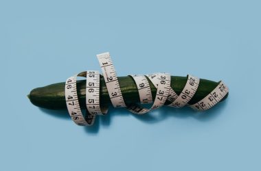 green cucumber and measuring tape