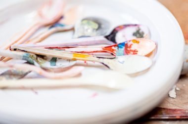 white ceramic plate with paint brushes