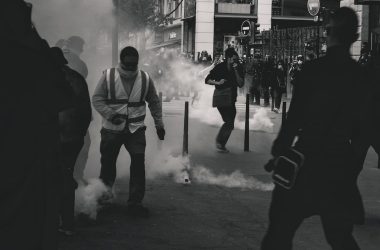grayscale photo of people near smoke