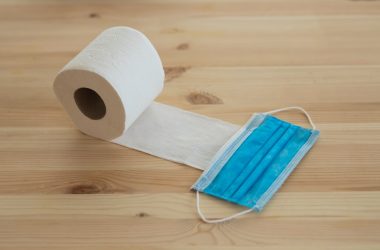 white toilet paper roll on brown wooden table