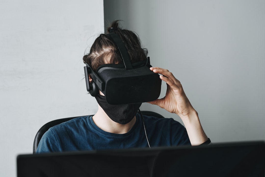man in blue crew neck shirt wearing black vr goggles