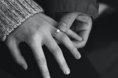 woman wearing wedding ring with man holding hand