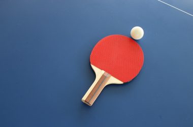 red and brown wooden table tennis racket