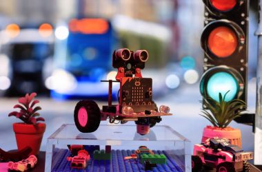 a toy robot is sitting on a table next to a traffic light