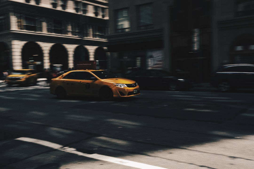 selective focus photo of beige metallic sedan