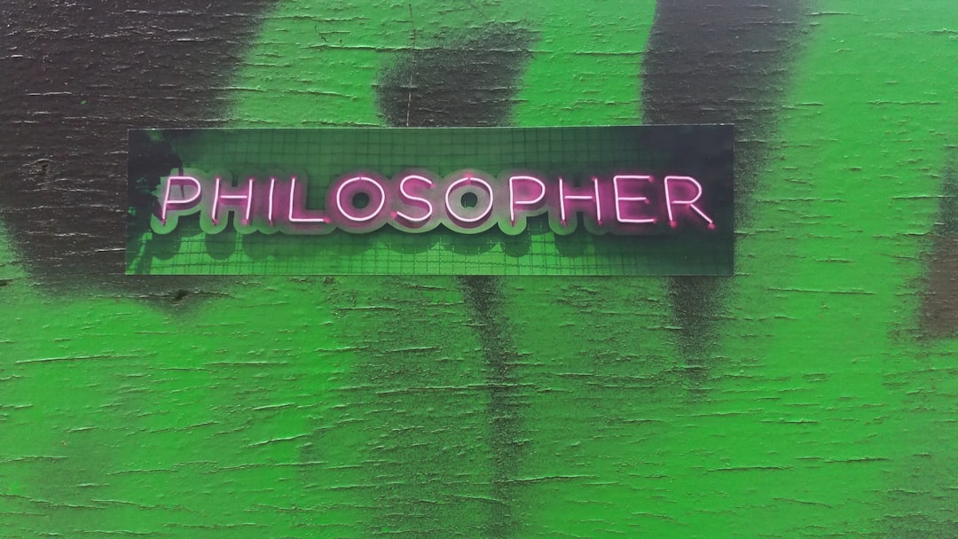 a green wall with a sign that says philosoher