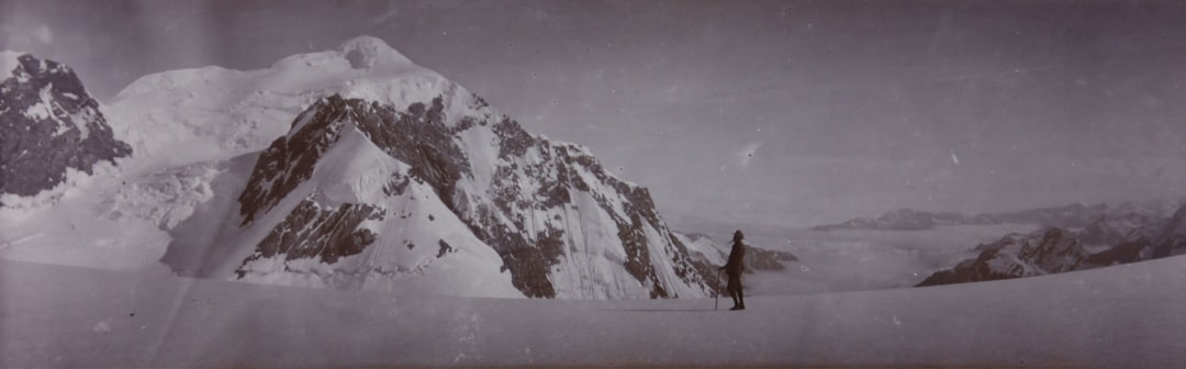 a man standing on top of a snow covered mountain