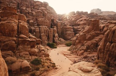 a person walking through a canyon in the desert