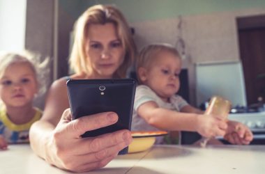 woman in white shirt holding black ipad