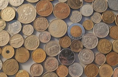 a pile of different coins sitting on top of each other