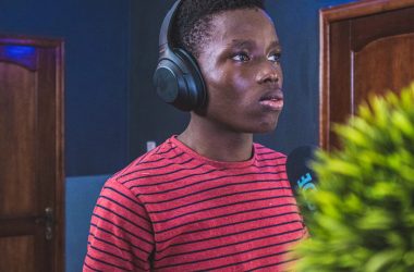 man in red and black striped crew neck shirt wearing headphones