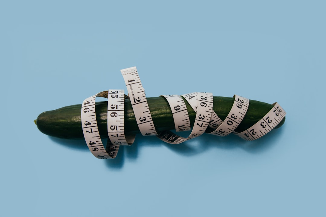 green cucumber and measuring tape