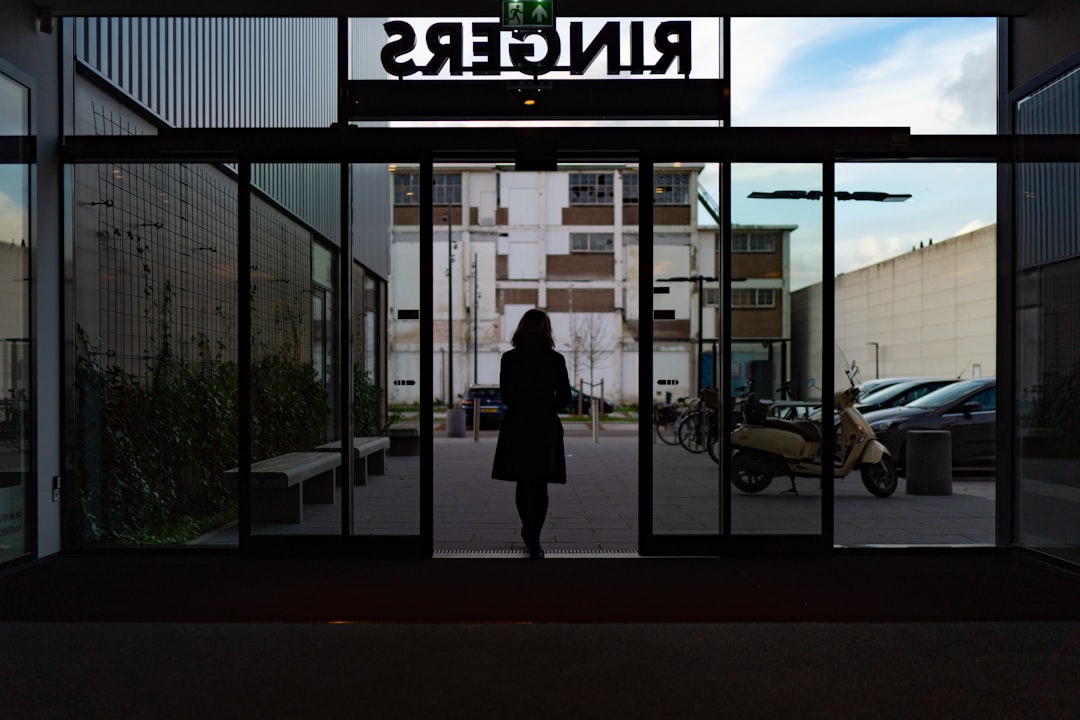 a woman is walking out of a building