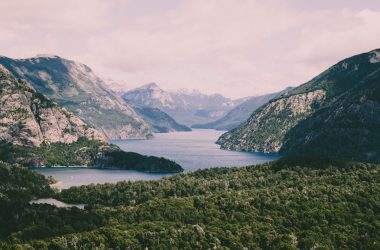 river in the middle of mountain under sky