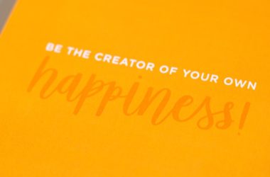 a yellow greeting card with the words be the creator of your own happiness