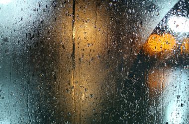 a wet window with a traffic light on it