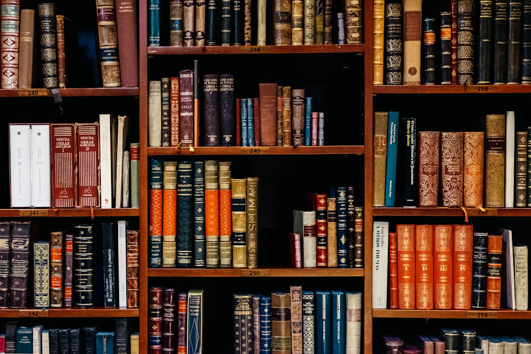 assorted-title of books piled in the shelves