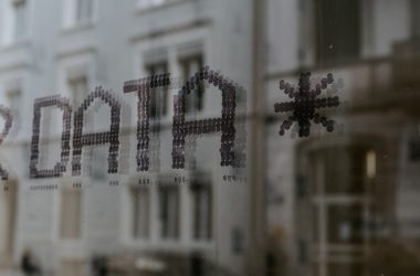 a close up of a window with a building in the background