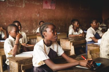 children sitting on chairs inside classroom