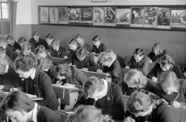 grayscale photo of people sitting on chair