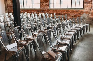 a room filled with lots of metal chairs