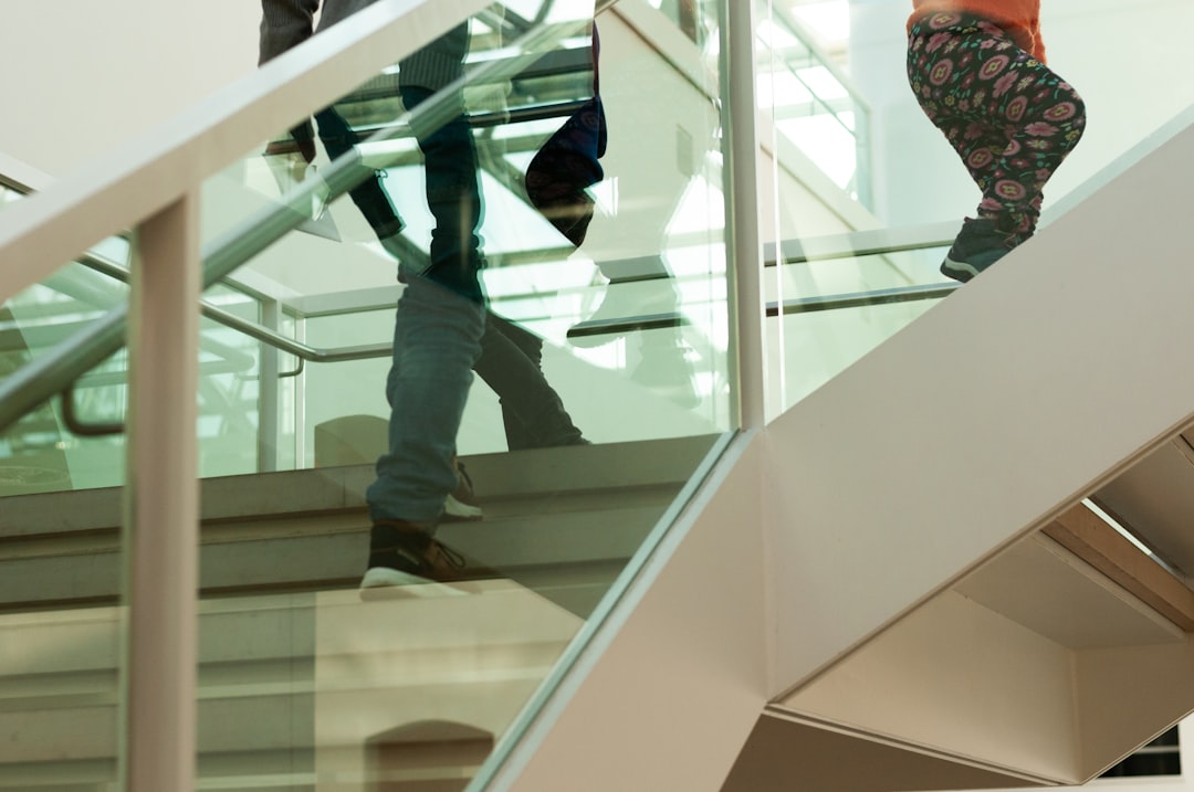 a couple of people walking down a set of stairs