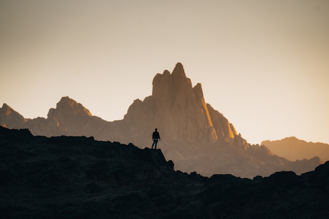 a person standing on top of a rocky hill