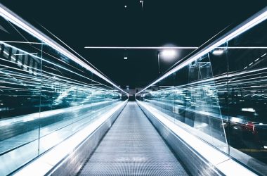 gray conveyor between glass frames at nighttime