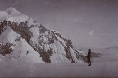 a man standing on top of a snow covered mountain