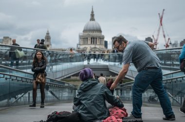 person sitting on floor near people