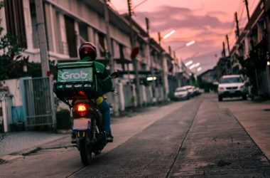 a person riding a motorcycle down a street