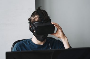 man in blue crew neck shirt wearing black vr goggles