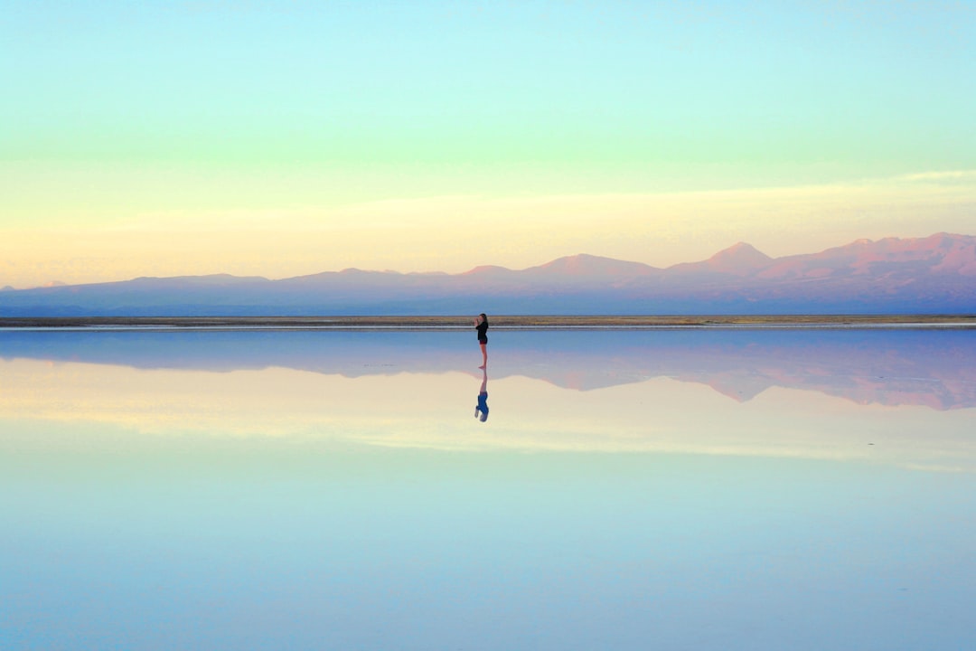 person standing near body of water during daytime