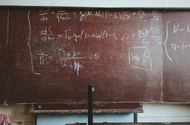 written equations on brown wooden board