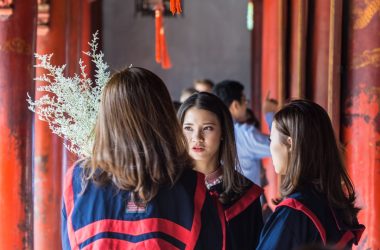 three women having conversation inside building