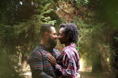 man and woman wearing button-up sports shirt on the center of trees