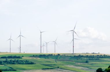 windmill surrounded by grass during daytime