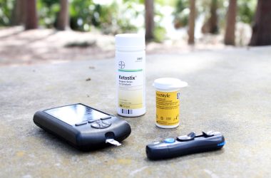 black smartphone beside white plastic bottle and black smartphone