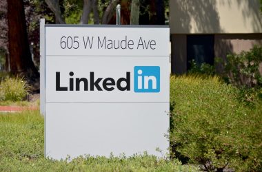 brown wooden signage on green grass field