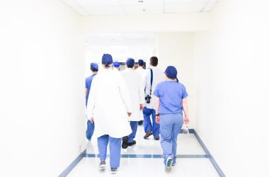 group of doctors walking on hospital hallway