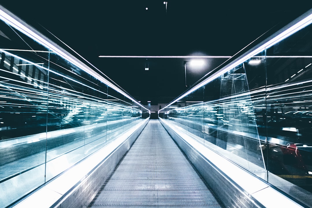 gray conveyor between glass frames at nighttime