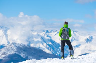 man standing on top of snow mountain