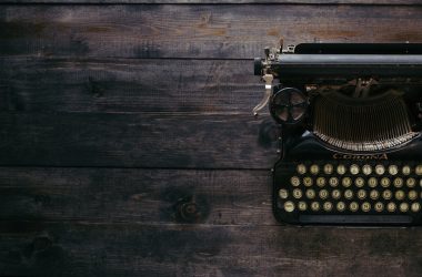 black Corona typewriter on brown wood planks