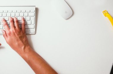 person typing on Apple Cordless Keyboard