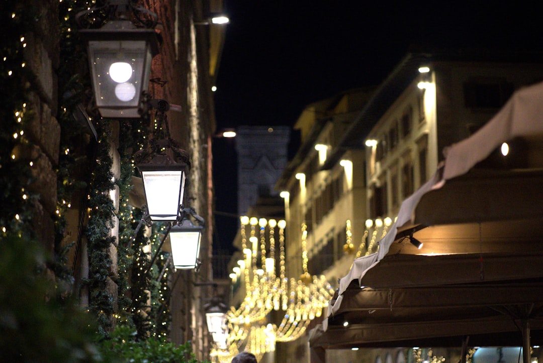 A person walking down a street at night