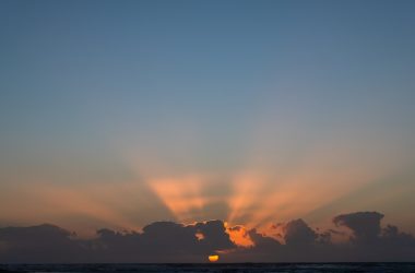 The sun is setting over a body of water