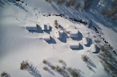 an aerial view of a snow covered field