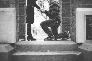 man kneeling in front of woman