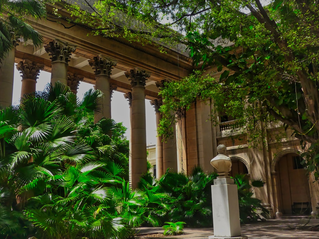 a building with columns and plants