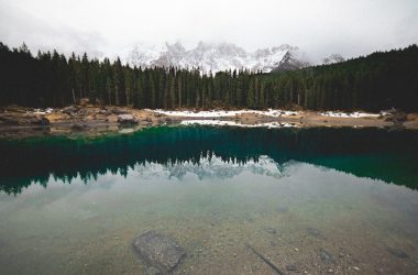 lake in forest near snow mountain